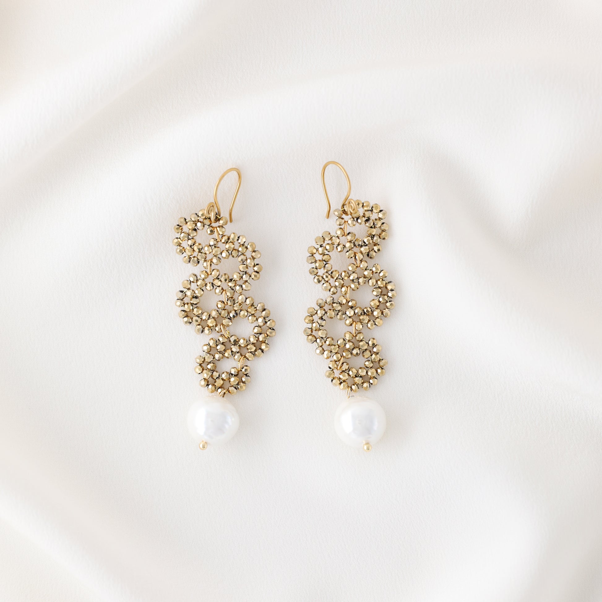 Product photo of handmade gold crystal snake earrings with pearl drop