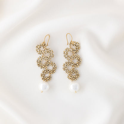 Product photo of handmade gold crystal snake earrings with pearl drop