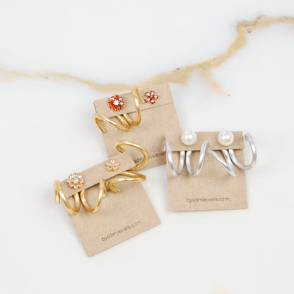 Gold and silver double loop Ear Jacket pairs displayed side by side with different example stud earrings, showing the two available color options.