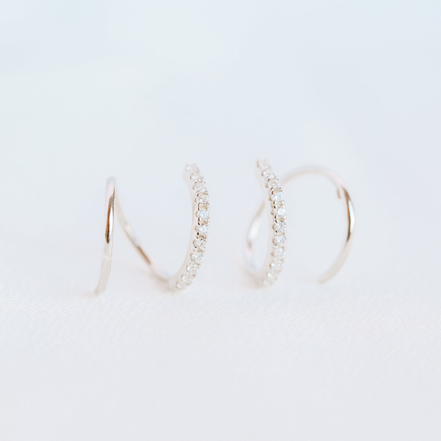 Lightweight gold twist hoop earring worn on ear