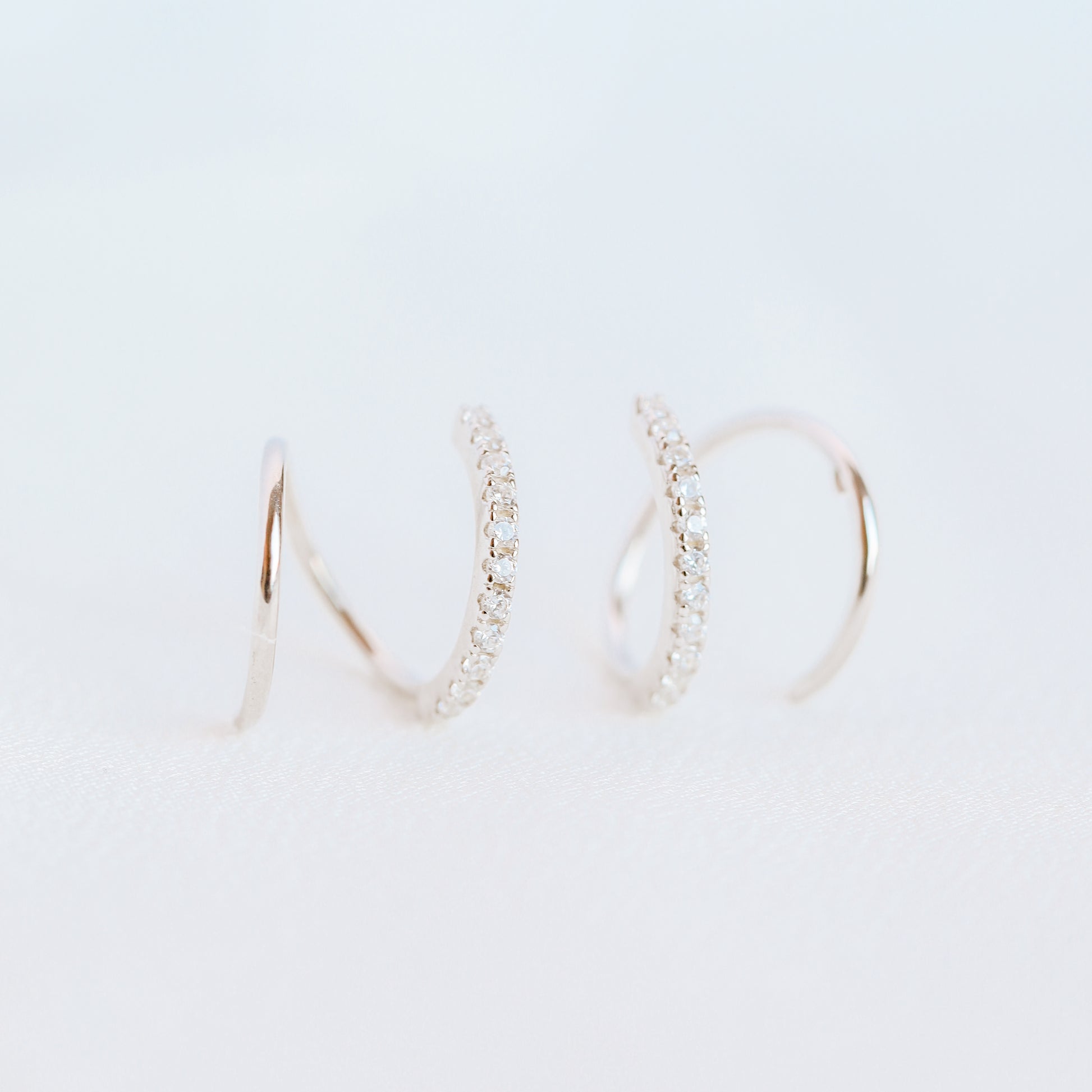 Lightweight gold twist hoop earring worn on ear