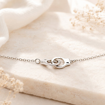 Dainty handcuff necklace worn as everyday symbolic jewelry