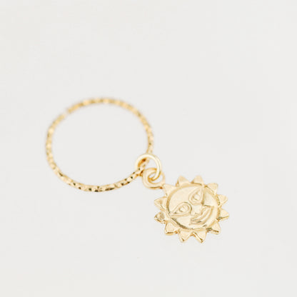 High-resolution shot of a single 18k gold plated sun charm hoop earring on a white background.