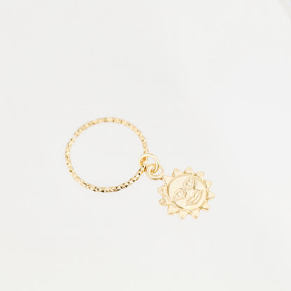 High-resolution shot of a single 18k gold plated sun charm hoop earring on a white background.
