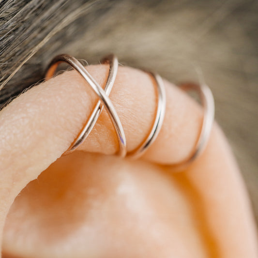 Handmade set of gold criss cross and double line helix ear cuffs for non-pierced ears, adjustable minimalist jewelry available in 12k gold filled, sterling silver, and 16 gauge black aluminum.