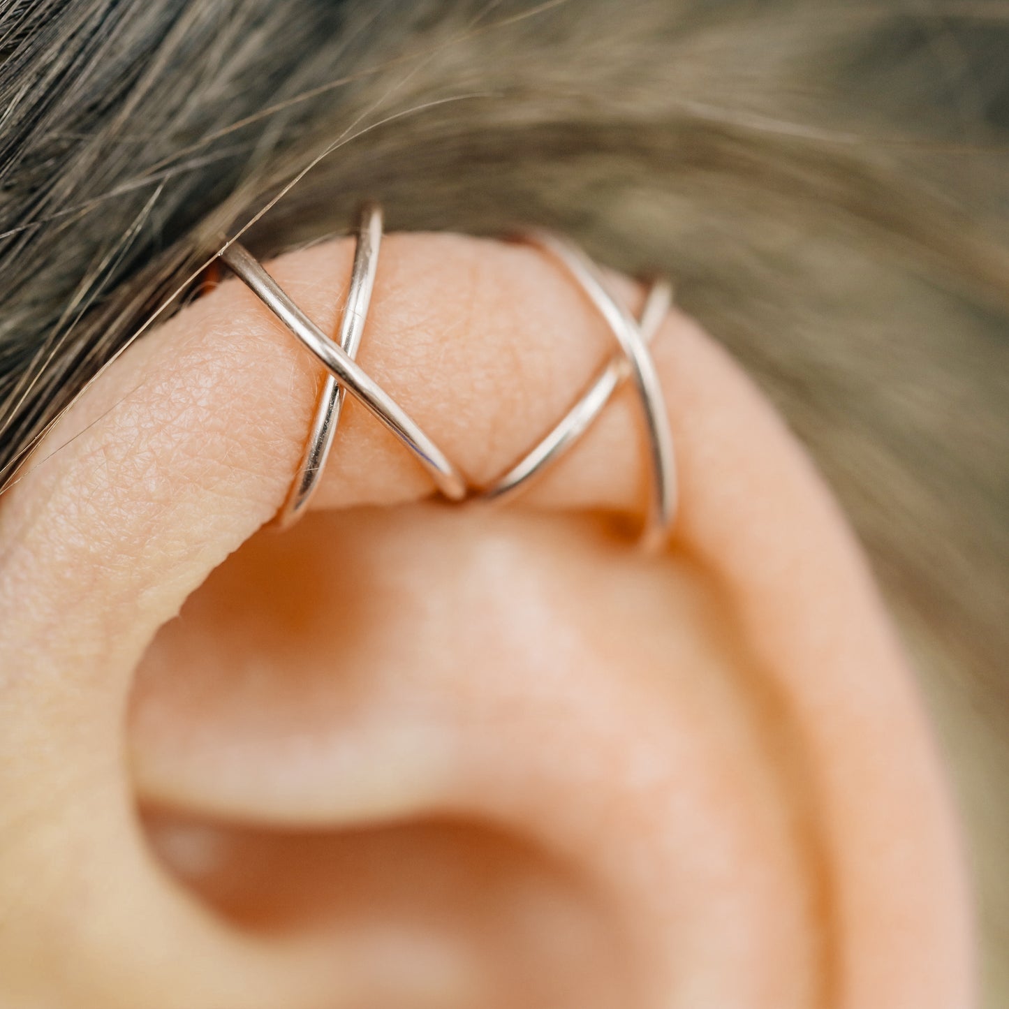 No-piercing double line and criss cross helix ear cuff shown on the upper ear, with smooth and diamond cut finish options for cartilage styling.