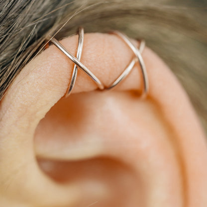 Handmade set of gold criss cross and double line helix ear cuffs for non-pierced ears, adjustable minimalist jewelry available in 12k gold filled, sterling silver, and 16 gauge black aluminum.