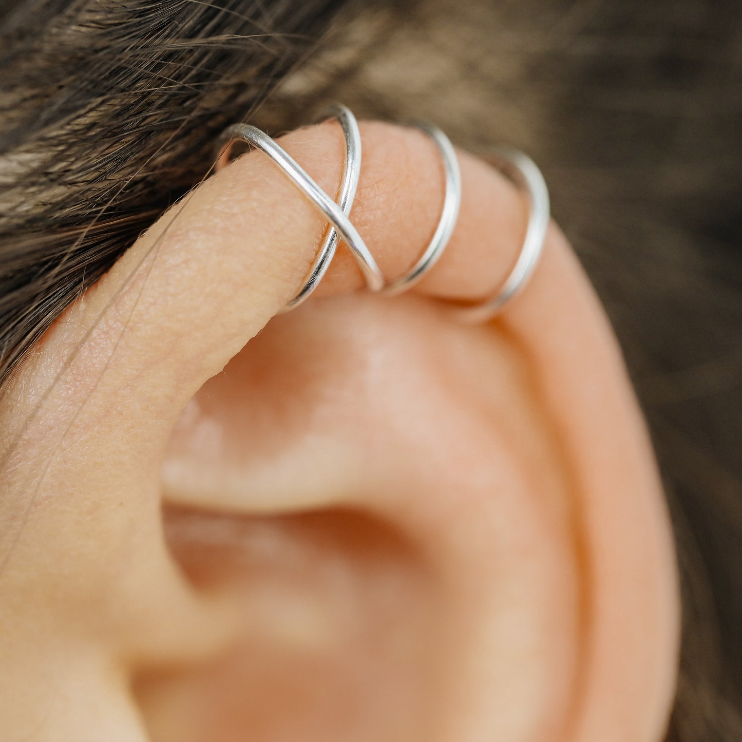 Handmade set of gold criss cross and double line helix ear cuffs for non-pierced ears, adjustable minimalist jewelry available in 12k gold filled, sterling silver, and 16 gauge black aluminum.
