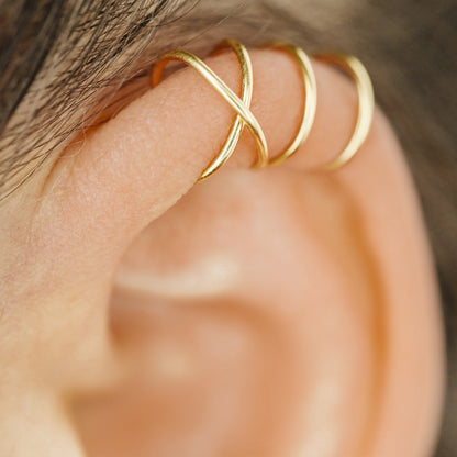 No-piercing double line and criss cross helix ear cuff shown on the upper ear, with smooth and diamond cut finish options for cartilage styling.