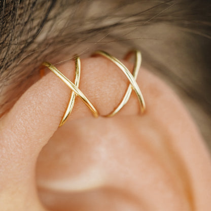 No-piercing double line and criss cross helix ear cuff shown on the upper ear, with smooth and diamond cut finish options for cartilage styling.