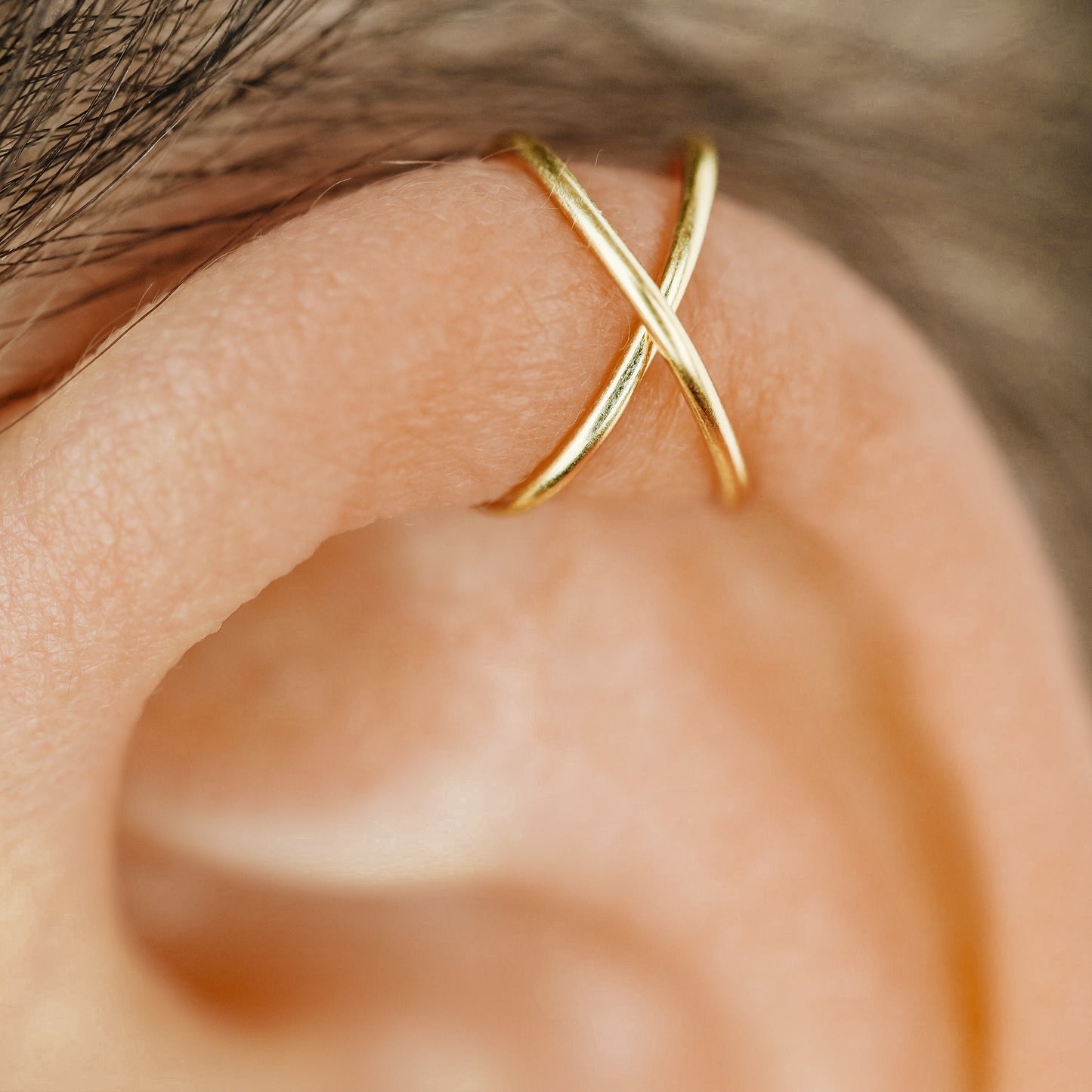 No-piercing double line and criss cross helix ear cuff shown on the upper ear, with smooth and diamond cut finish options for cartilage styling.