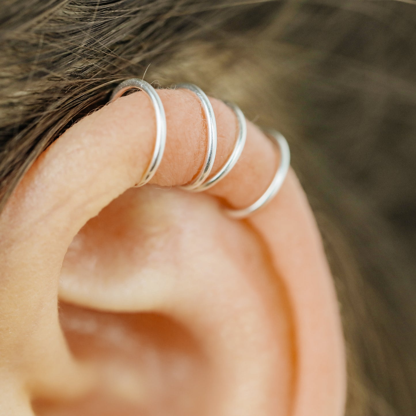 Handmade set of gold criss cross and double line helix ear cuffs for non-pierced ears, adjustable minimalist jewelry available in 12k gold filled, sterling silver, and 16 gauge black aluminum.