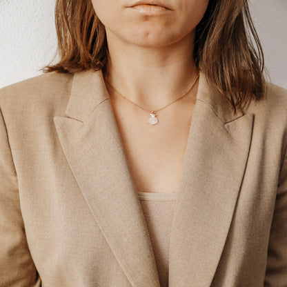 Ladybug necklace worn by model with beige blazer for elegant everyday styling