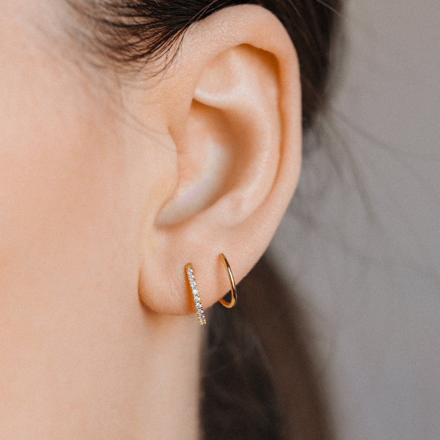 Curved CZ hoop earring showing front and side view