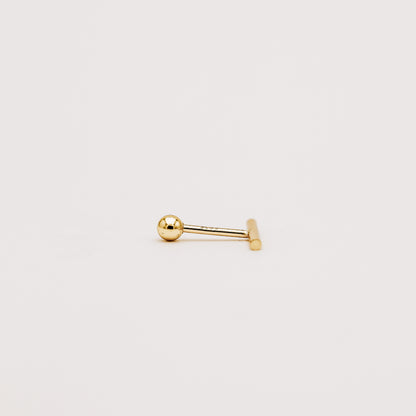 Close up of minimal bar screw back earring with polished gold finish