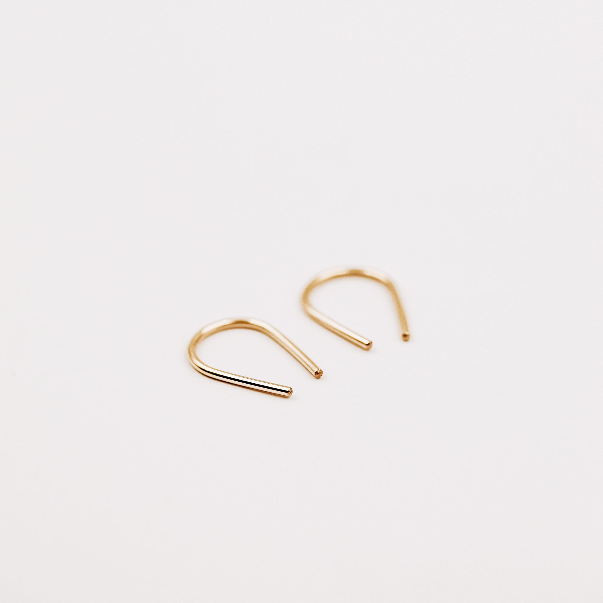 Gold filled U shape earrings displayed on white background