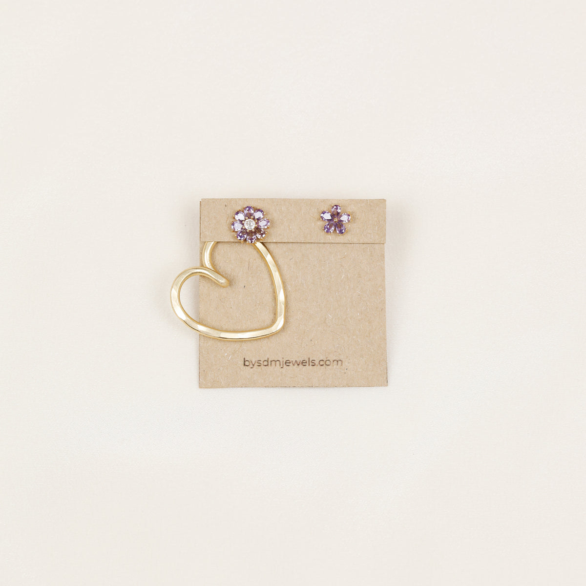 One handmade gold Heart Ear Jacket displayed with decorative flower stud earrings, illustrating the One Ear Jacket option and asymmetric styling possibility.