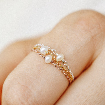 Close up detail of tiny freshwater pearls on delicate chain ring