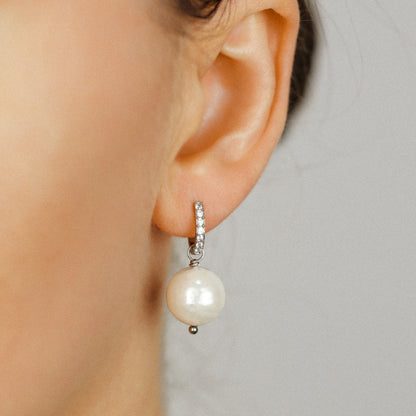 Pearl drop hoop earring worn on brunette model showing the small crystal hoop and round pearl drop