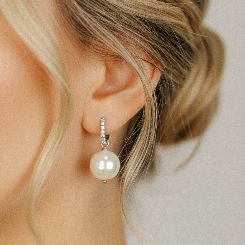 Pearl drop hoop earring worn on blonde model with round ceramic pearl and sparkling silver hoop