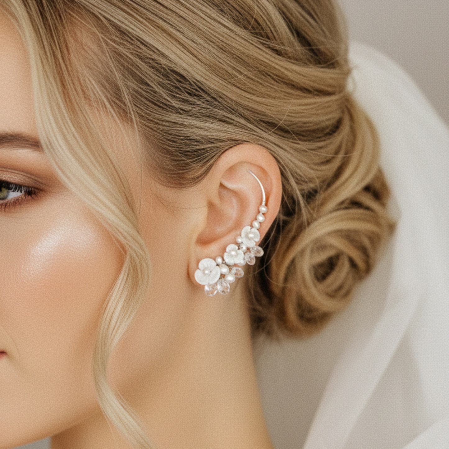 Close up of floral pearl ear climbers following the curve of the ear