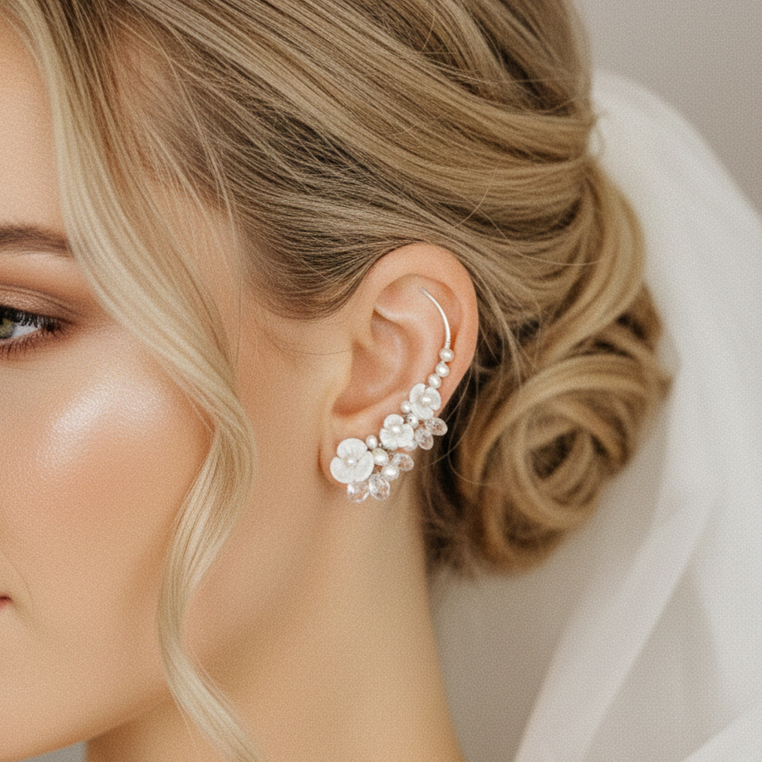 Close up of floral pearl ear climbers following the curve of the ear