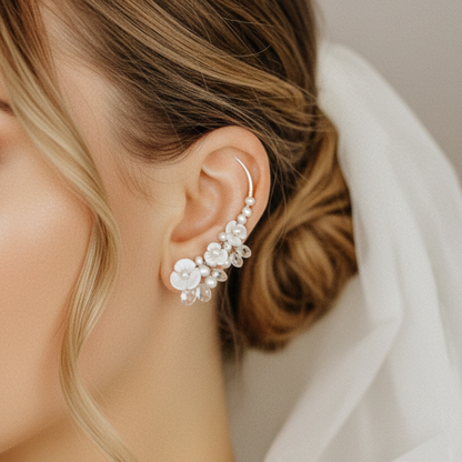 Close up of floral pearl ear climbers following the curve of the ear