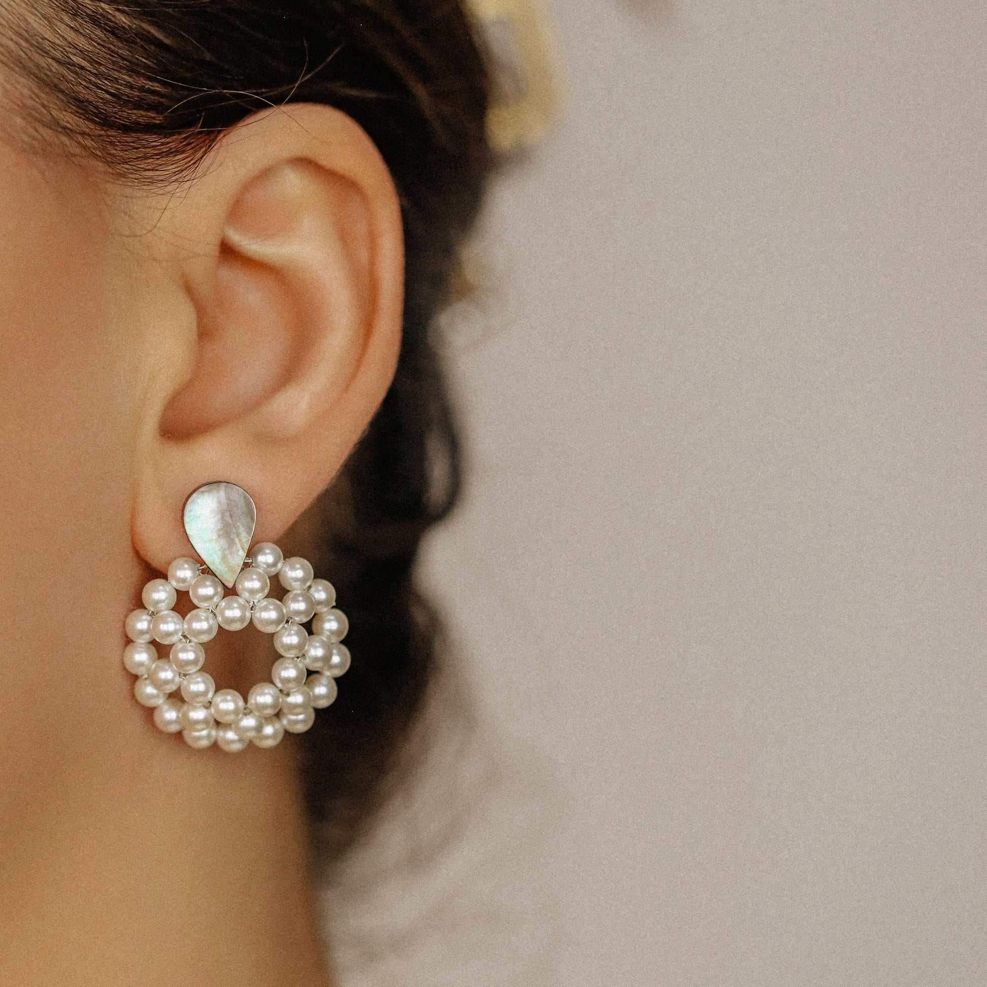 Pearl hoop dangle earrings worn in golden hour light with elegant statement look
