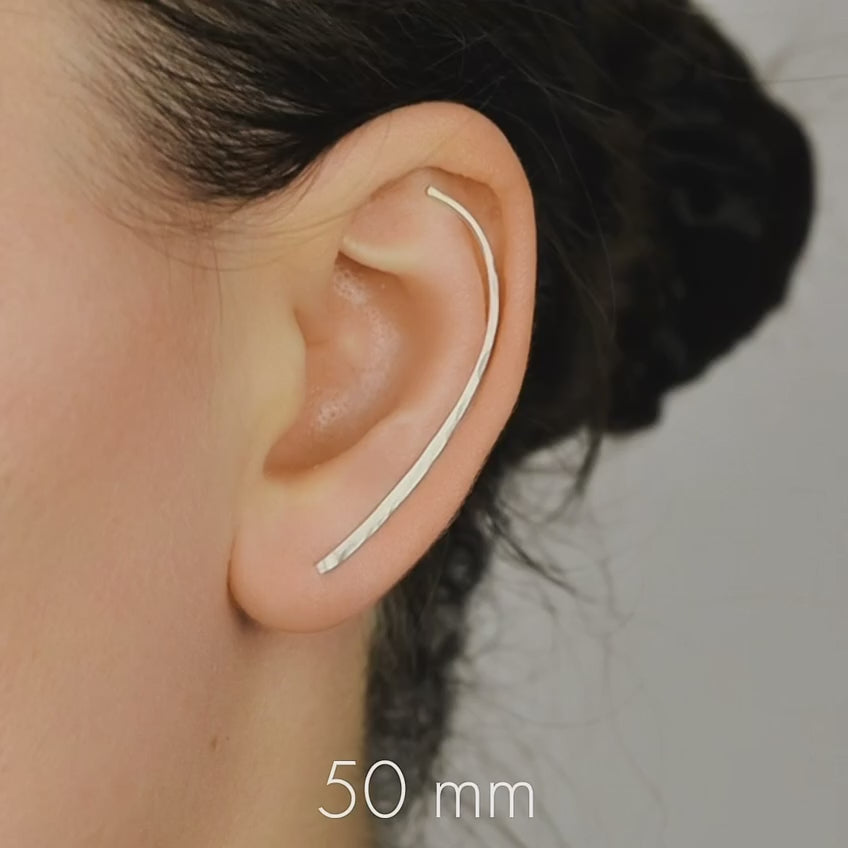 Handmade 50 mm minimalist ear climber earrings worn through one standard lobe piercing and rotated upward to follow the natural curve of the ear, featuring a long clean hand hammered wire design with an elegant ear sweep shape, available as a single left ear climber, single right ear climber or pair in solid 925 sterling silver, 14k gold filled and 14k rose gold filled, with length options from 10mm to 50mm.
