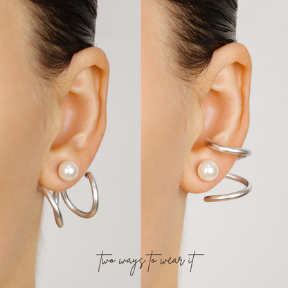 Silver double loop Ear Jacket shown worn in two different orientations behind the earlobe with a pearl-style stud, demonstrating two ways to position the design.
