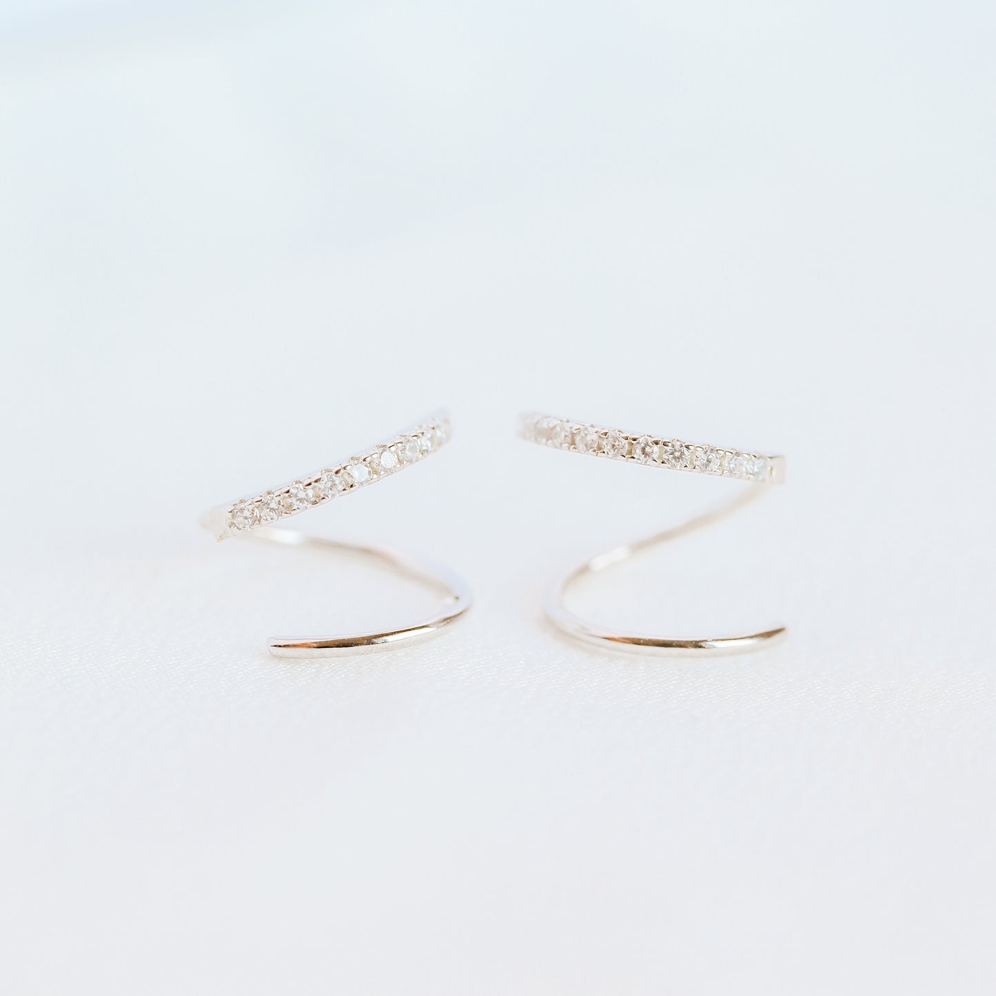 Lightweight gold twist hoop earring worn on ear