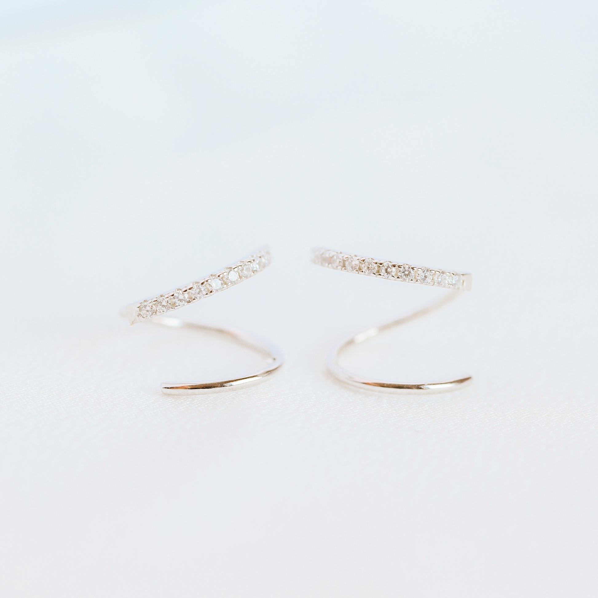 Lightweight gold twist hoop earring worn on ear