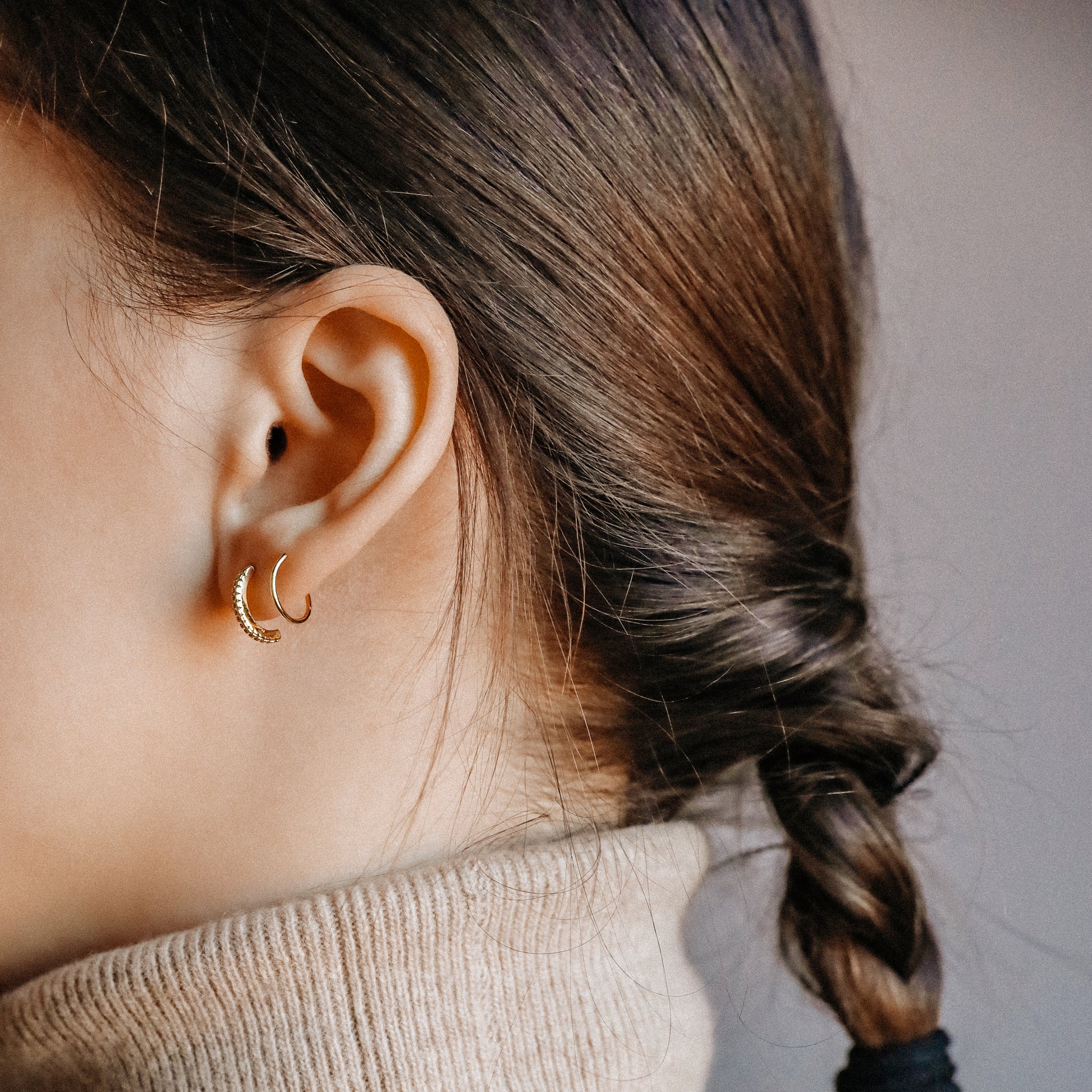 Twist double hoop illusion earring with CZ stones in gold finish