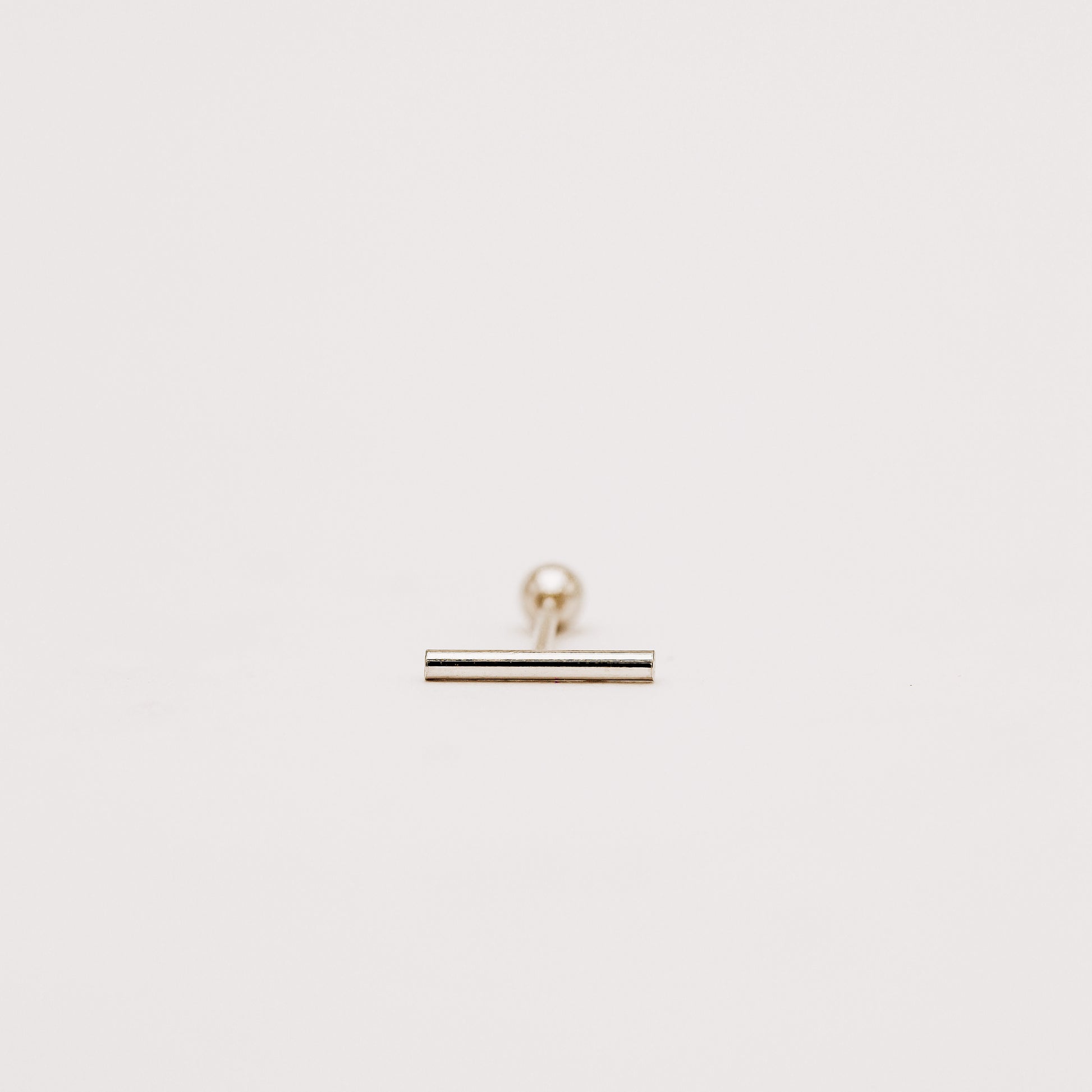 Thin bar screw back earring designed for comfortable daily wear