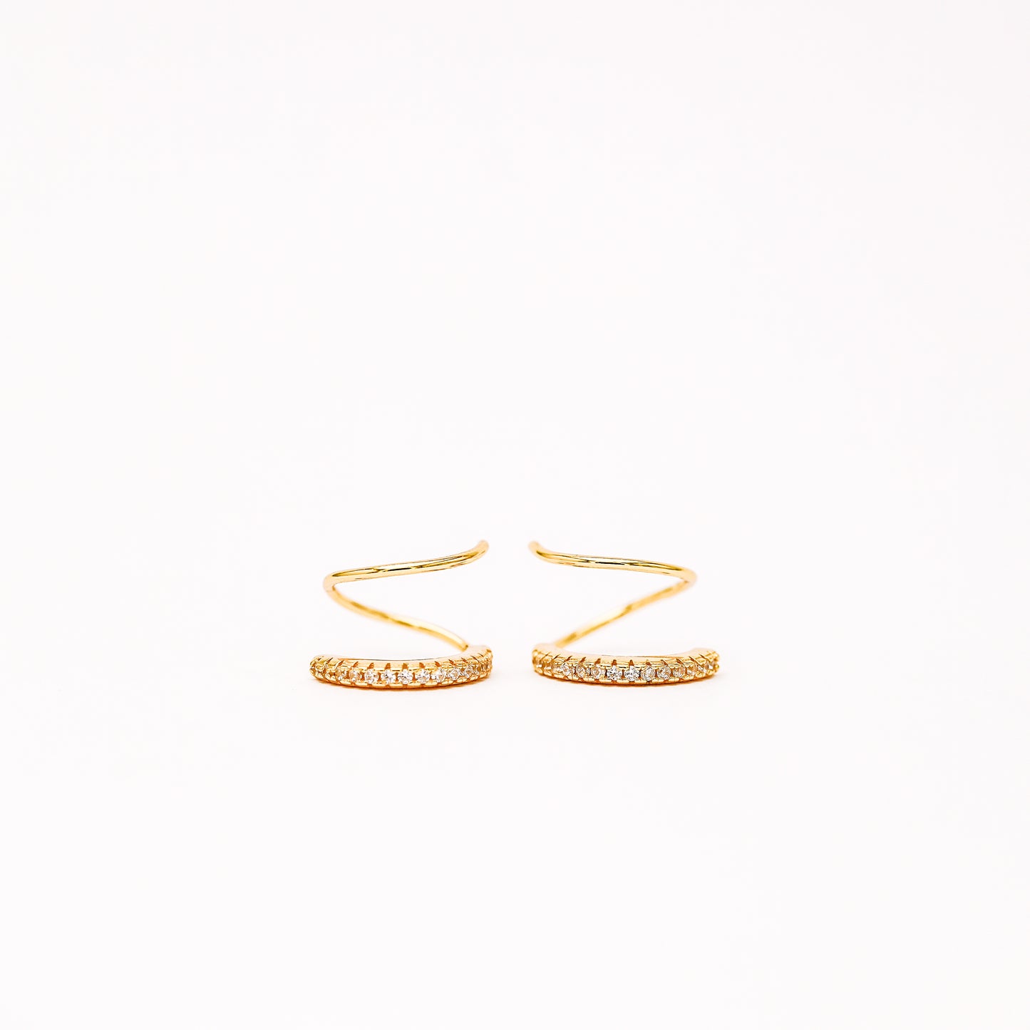 Lightweight gold twist hoop earring worn on ear