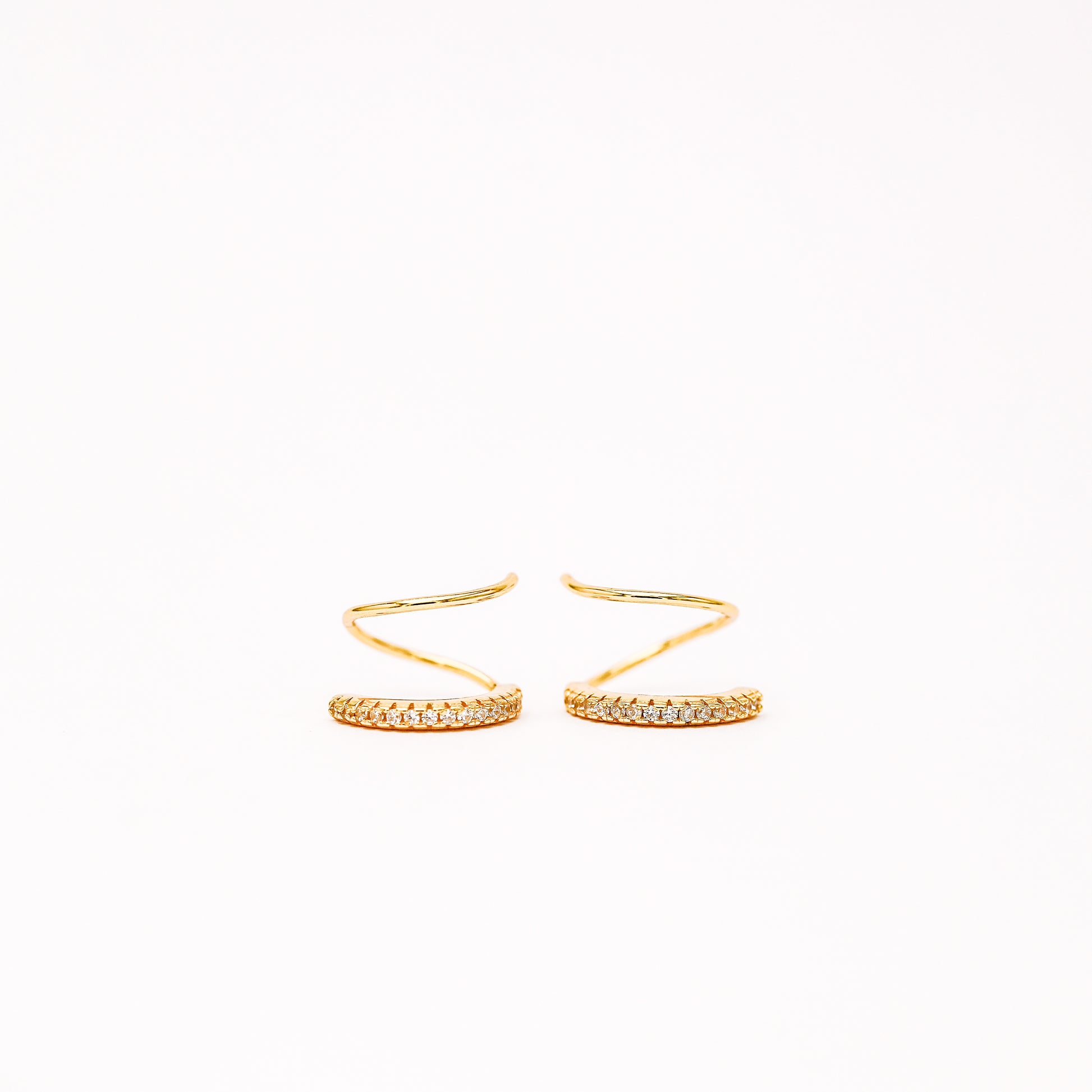 Lightweight gold twist hoop earring worn on ear
